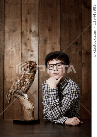 Young child, portrait and confident with thinking by owl, pride and vintage fashion with glasses in mockup. Boy, face and nerd with wise bird in retro clothes with eyewear, contemplation and smart 139445999