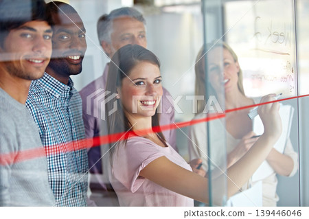 Happy woman, team and writing on glass board for schedule planning, meeting or creative strategy at office. Portrait of employee group smile in teamwork, collaboration or startup project at workplace Happy woman, team and writing on glass board for schedule planning, meeting or creative strategy at office. Portrait of employee group smile in teamwork, collaboration or startup project at workplace 139446046