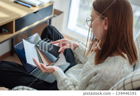 Woman choosing color swatches for home interior design project Woman choosing color swatches for home interior design project 139446191