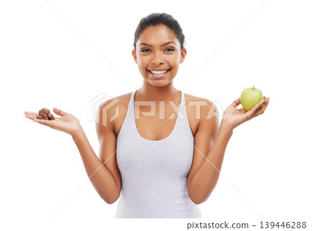 Apple, chocolate and woman for healthy food choice or offer with food, sugar and diet on a white background. Portrait of happy young person with green fruit, detox and lose weight decision in studio Apple, chocolate and woman for healthy food choice or offer with food, sugar and diet on a white background. Portrait of happy young person with green fruit, detox and lose weight decision in studio 139446288