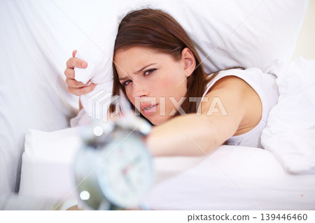 Alarm, clock and angry woman in a bed frustrated with sound, alert or wake up noise at home. Time, stop and face of annoyed female person in bedroom with insomnia, crisis or snooze disaster in house Alarm, clock and angry woman in a bed frustrated with sound, alert or wake up noise at home. Time, stop and face of annoyed female person in bedroom with insomnia, crisis or snooze disaster in house 139446460
