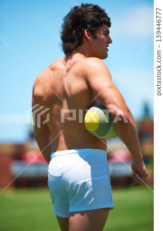 Back, shirtless and male rugby player with a ball thinking on a field for sports plan and game. Competition, workout and training with a topless athlete with vision and strategy outdoors 139446777