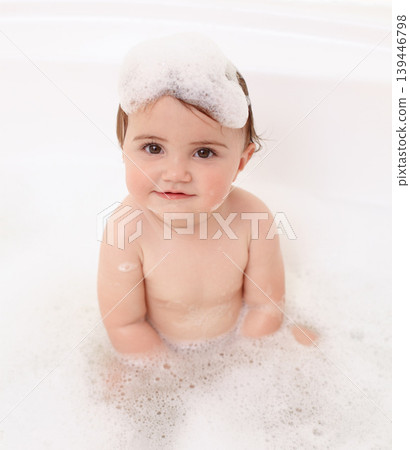Baby in bath with soap, water and portrait of clean fun in for skincare, wellness and hygiene. Bubbles in bathtub, foam and child in bathroom with cute face, care and washing dirt, germs and smile. Baby in bath with soap, water and portrait of clean fun in for skincare, wellness and hygiene. Bubbles in bathtub, foam and child in bathroom with cute face, care and washing dirt, germs and smile. 139446798