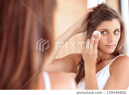 Skincare, cleaning and woman in mirror with cotton pad, makeup or dirt removal with luxury skin product in home. Dermatology, cosmetics and girl with beauty treatment, facial care or wipe in bathroom Skincare, cleaning and woman in mirror with cotton pad, makeup or dirt removal with luxury skin product in home. Dermatology, cosmetics and girl with beauty treatment, facial care or wipe in bathroom 139446908