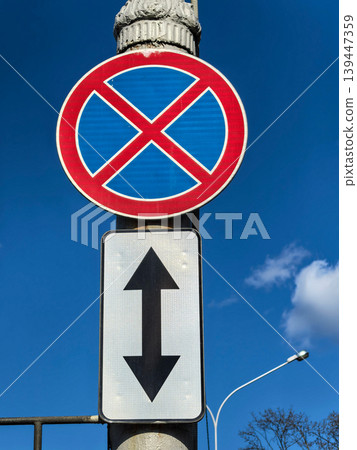 No Standing and No Parking Traffic Sign with Arrow Under Blue Sky No Standing and No Parking Traffic Sign with Arrow Under Blue Sky 139447359