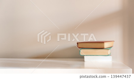 Stack of books on white desk with copy space Stack of books on white desk with copy space 139447437