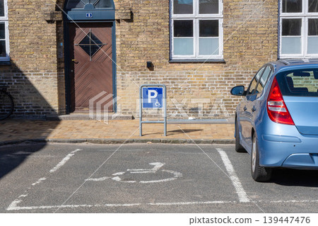 Accessible parking space for disabled people near residential building entrance. Accessible parking space for disabled people near residential building entrance. 139447476