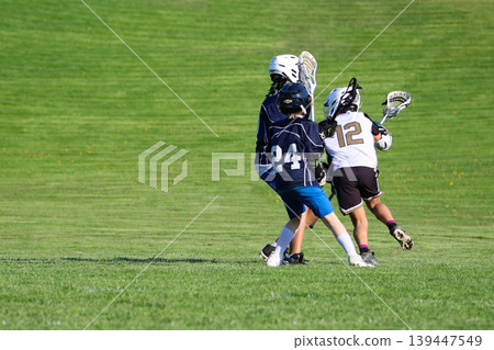 Young boys playing Lacrosse game Young boys playing Lacrosse game 139447549