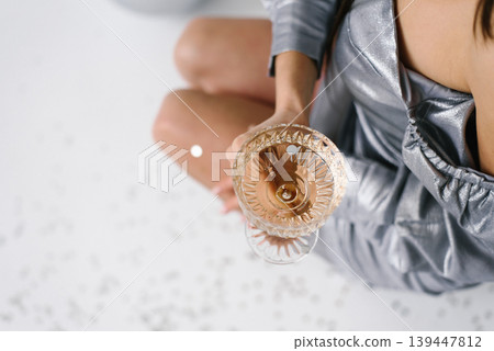Festive Party Celebration With Champagne Glass And Silver Confetti Festive Party Celebration With Champagne Glass And Silver Confetti 139447812