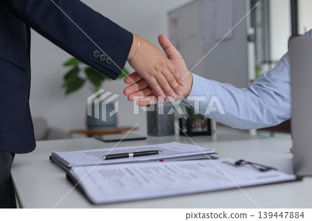 Human Resources Manager Shaking Hands with Candidate After Successful New Job Recruitment. Human Resources Manager Shaking Hands with Candidate After Successful New Job Recruitment. 139447884