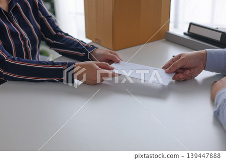 Manager Terminating Employee and Handing Over Severance Document. Manager Terminating Employee and Handing Over Severance Document. 139447888