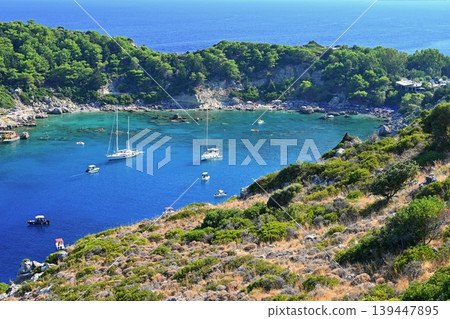 Peaceful seaside scenery on Rhodes island in Greece, clear water and relaxing summer atmosphere. Peaceful seaside scenery on Rhodes island in Greece, clear water and relaxing summer atmosphere. 139447895