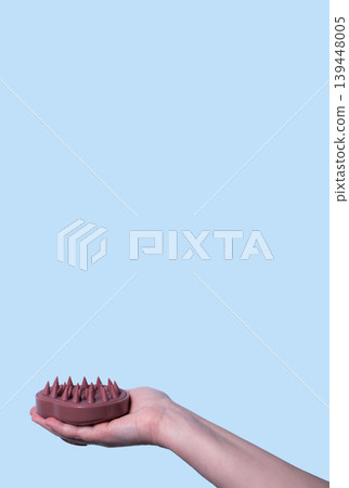 Pink head massager hair brush with silicone flexible hair care and head relaxation. Mock up isolated. Vertical image Pink head massager hair brush with silicone flexible hair care and head relaxation. Mock up isolated. Vertical image 139448005