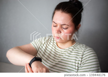 Woman watching on health tracking app. Reading health summary without anxiety. Shift from compulsive hyper focus on checking data to calm living. Modern technologies as assistant not stress 139448176