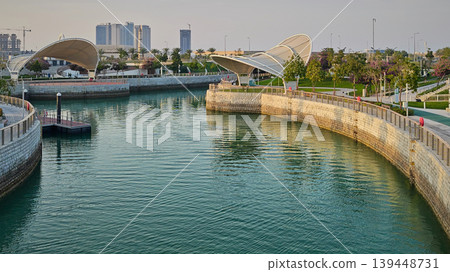 Qetaifan Island North, Lusail Qatar-February 12 2026: Majra Al Sail Park in Lusail offers canal views, lush gardens, kids' play areas, picnic zones, and walking trails along a 1.3 km saltwater canal. Qetaifan Island North, Lusail Qatar-February 12 2026: Majra Al Sail Park in Lusail offers canal views, lush gardens, kids' play areas, picnic zones, and walking trails along a 1.3 km saltwater canal. 139448731