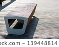 Modern Wooden Bench on Sunlit Decking for Urban Outdoor Spaces and Architectural Design Inspiration 139448814