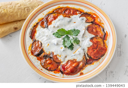 Burani Bonjan Afghan eggplant dish with yogurt garlic sauce and parsley garnish Burani Bonjan Afghan eggplant dish with yogurt garlic sauce and parsley garnish 139449043