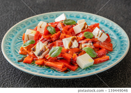 Mediterranean salad with roasted peppers feta basil and balsamic glaze 139449046
