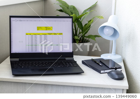 Laptop screen on the modern desk showing spreadsheet with loan amortization table Laptop screen on the modern desk showing spreadsheet with loan amortization table 139449060