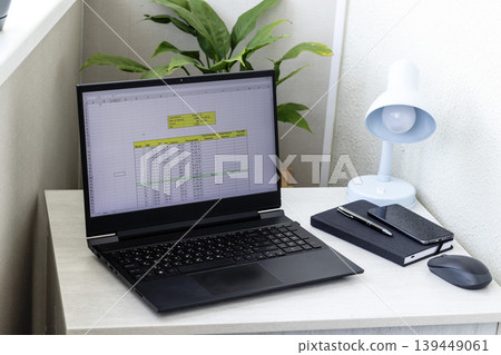 Laptop screen on the modern desk showing spreadsheet with loan amortization table 139449061