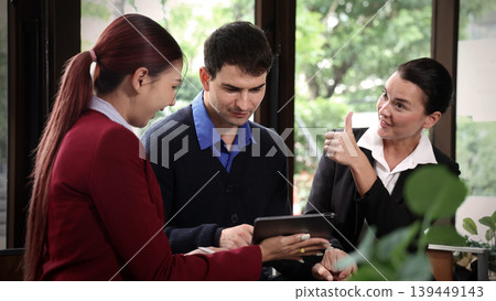Deal Business. Business professionals discussing projects and digital information on tablet during corporate meeting. Team collaboration communication connect and client consultation in modern office 139449143