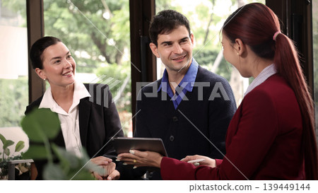 Deal Business. Business professionals discussing projects and digital information on tablet during corporate meeting. Team collaboration communication connect and client consultation in modern office Deal Business. Business professionals discussing projects and digital information on tablet during corporate meeting. Team collaboration communication connect and client consultation in modern office 139449144