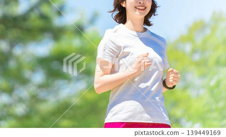 A woman running in the greenery A woman running in the greenery 139449169
