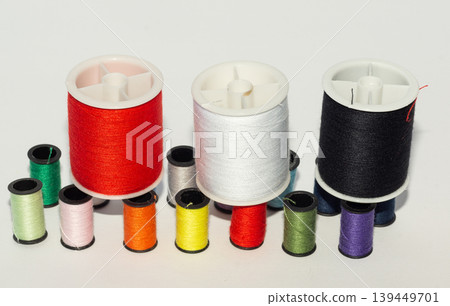 A row of spools of colored thread for the background. A row of spools of colored thread for the background. 139449701