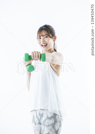 Young women sportswear looking at the camera dumbbell punch 139450470