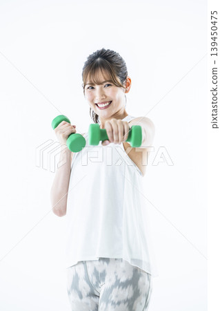 Young women sportswear looking at the camera dumbbell punch 139450475