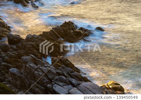 The sacred sunset over Yakushima Island: Waves and sunbeam (winter) The sacred sunset over Yakushima Island: Waves and sunbeam (winter) 139450549