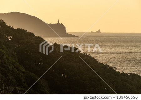 A sacred sunset over Yakushima Island: Yakushima Lighthouse and a ship (winter) A sacred sunset over Yakushima Island: Yakushima Lighthouse and a ship (winter) 139450550