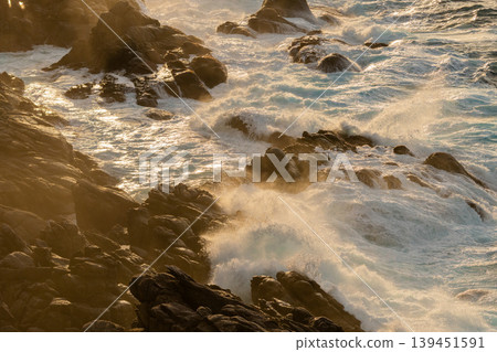 The sunset over Yakushima, where gods reside, and the rough sea (winter) The sunset over Yakushima, where gods reside, and the rough sea (winter) 139451591