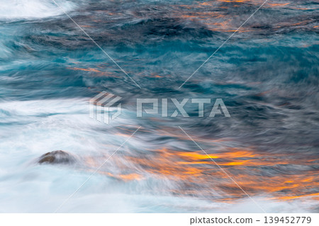 The sacred sunset over Yakushima Island: Sunset and reflection in the water (winter) The sacred sunset over Yakushima Island: Sunset and reflection in the water (winter) 139452779