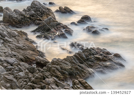 The sunset over Yakushima, where gods reside, shimmering in the waves (winter) 139452927