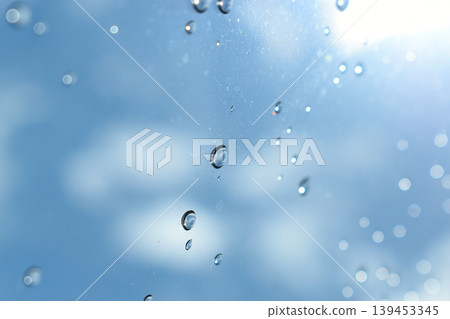 water drop on mirror with blue sky and white cloud background 139453345