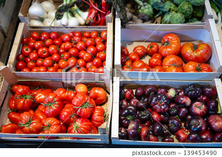 Fresh red tomatoes displayed on store counter for sale Fresh red tomatoes displayed on store counter for sale 139453490