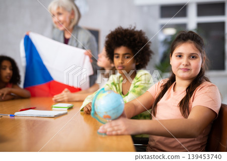 students listen to woman teacher who talks about Czech 139453740
