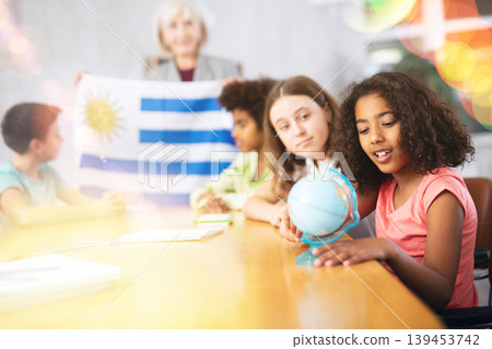 students listen to woman teacher who talks about Uruguay students listen to woman teacher who talks about Uruguay 139453742
