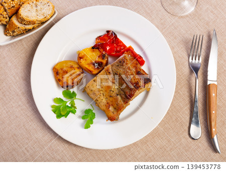 Grilled ribs cooked with whole bell pepper are garnished with potato 139453778