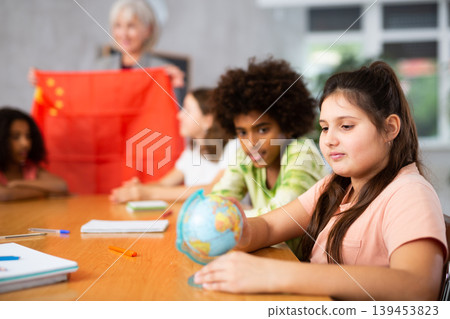 students listen to woman teacher who talks about China students listen to woman teacher who talks about China 139453823