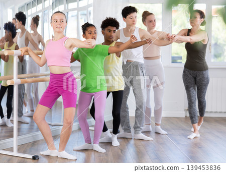 Teenage girl practicing plie position of ballet during choreography classes 139453836