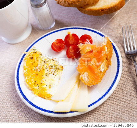 Salted salmon, fried eggs, cheese and ripe tomatoes - delicious breakfast 139453846