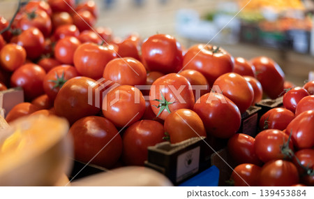 Fresh red tomatoes displayed on store counter for sale Fresh red tomatoes displayed on store counter for sale 139453884