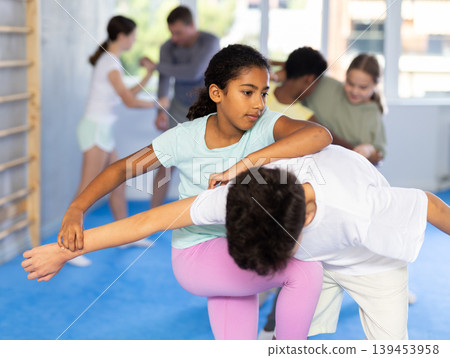 Boy and girl practicing self-defense techniques 139453958
