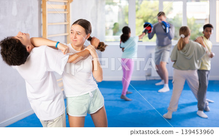 Boy and girl practicing self-defense techniques 139453960