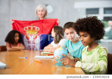 Mature woman teacher tells pupils the history of Serbia 139454029