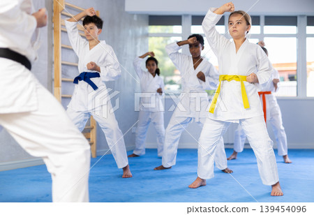 Group of children train karate techniques 139454096