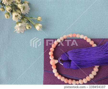 Prayer beads and prayer bead case with a light blue background Prayer beads and prayer bead case with a light blue background 139454107