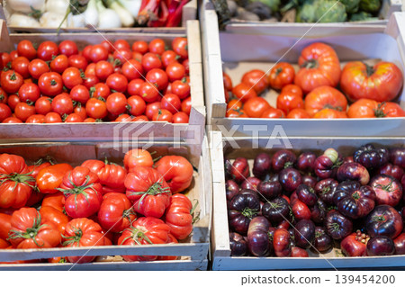 Fresh red tomatoes displayed on store counter for sale 139454200